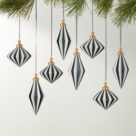 A nod to vintage European design, hand-painted glass ornaments feature striking black and white stripes on unique silhouettes. Topped with a gold cap and sheer black ribbon for hanging. Set of eight includes four tall and four wide ornaments. CB2 exclusive.  -Hand-painted -Glass -Sheer black ribbon -Set of eight -Wipe with a soft cloth -Imported Bordeaux Black and White Glass Christmas Tree Ornaments Set of 8 European Christmas Decor, Tinsel Christmas, Modern Christmas Ornaments, Black And White Christmas, Black White Christmas, Gold Christmas Ornaments, White Christmas Ornaments, Unique Holiday Decor, Holiday 2024