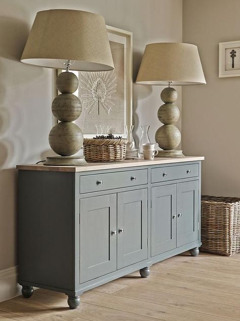 Cottage dining room features walls painted taupe lined with a gray sideboard cabinet topped with butcher block and stacked sphere lamps atop a pine floor. Cabinet With Butcher Block Top, Dining Room Feature Wall, Vstupná Hala, Cottage Dining Rooms, Dining Room Cabinet, Butcher Block Top, Grey Interior Design, Sideboard Grey, Muebles Living