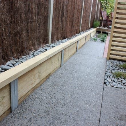 How to build a retaining wall | Home Hardware Wooden Garden Borders, Concrete Sleeper Retaining Walls, Sleeper Retaining Wall, Retaining Wall Steps, Backyard Retaining Walls, Building A Retaining Wall, Landscaping Retaining Walls, Garden Border, Garden Steps