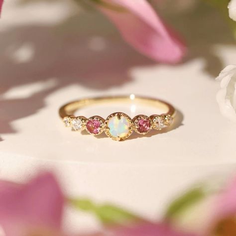 Introducing the Lira Ring ✨🌹 exclusively available at www.unrival.in via link in bio ❤️ With a mesmerizing opal centerpiece and vibrant pink accents, Lira exudes timeless elegance and a touch of whimsy. Perfect for those unforgettable moments that deserve something truly unique.🌹 Make a statement with Lira today! 💫🥰 This keeps the tone elegant and highlights the key features of the ring.🥰 • • • • • • • • opal ring, pink gemstones, diamond accents, gold opal ring, unique engagement ring, lu... Bff Rings, Vintage Style Rings, Tourmaline Ring, Shop Engagement Rings, Engagement Ring Wedding Band, Pink Opal, Red Garnet, Bridal Gifts, White Topaz