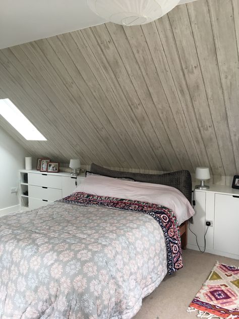 I really love my wood effect wallpaper. Perfect for a blank sloped ceiling. Loft Bedroom Ideas Sloped Ceiling Paint, Slanted Wall Wallpaper, Slanted Roof Bedroom Sloped Ceiling, Rooms With Angled Ceilings, Small Loft Bedroom Ideas Low Ceiling, Half Slanted Ceiling Bedroom, Sloped Bedroom Ideas, Triangle Ceiling Bedroom, Bedroom With Eaves