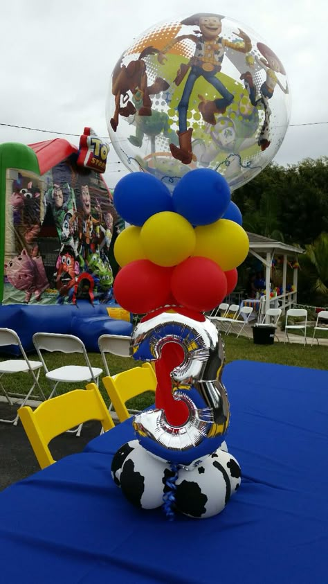 Toy story centerpiece Toy Story Flower Arrangements, Toy Story Balloon Centerpieces, Centros De Mesa Toy Story Ideas, Toy Story Birthday Centerpieces, Toy Story Table Centerpieces, Toy Story Centerpieces Ideas, Toy Story Centerpieces, Woody Birthday, Toy Story Party Decorations