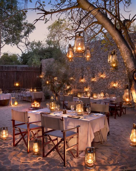 The magic and mystery of African feast in the traditional boma style setting. Ngala Safari Lodge with a romantic colonial style inspired design is in the middle of African bush charm is a luxury private game reserve built next to the famed Kruger National Park. Gala Setup, Safari Lodge Decor, Safari Lodge Interior, Rustic Restaurant Interior, Safari House, Garden Celebration, Lodges South Africa, African Safari Lodge, African Lodges