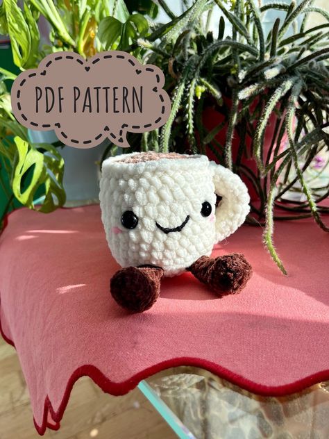 🤎This mug crochet pattern features an adorable face and little legs, great for gift giving or as a personal plushie friend🤎 ☕️ Suitable for beginners and experienced crocheters alike, this pattern provides a fun and engaging project for all skill levels ☕️ Perfect size for an easy crochet project *PATTERNS ARE IN ENGLISH* Crochet For Teachers, Coffee Cosy Crochet, Crochet Gifts Plushies, Crochet Pillows Cute Asthetic Crochet, Mug Cosies Crochet, Crochet Coffee Plushie, Coffee Mug Crochet, Crochet Boba Plush, Mug Crochet