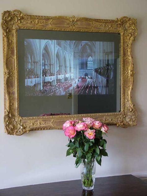 Ornate Regency Swept frame surrounding two way mirrored TV with TV on. Ornate Tv Frame, Samsung Frame Tv With Gold Frame, Tv With Gold Frame, Vintage Tv Frame, Gold Frame Around Tv, Gold Framed Tv, Tv Gold Frame, Gold Frame Tv, Gold Tv Frame