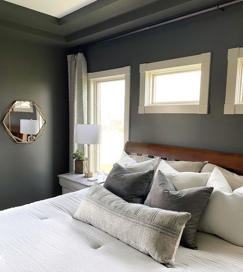 This owner’s suite is transformed with a dark gray/green paint from Sherwin Williams, Grizzle Gray. Project: Rustic Comfort Owner’s Suite Design: Homes by Simmone Master bedroom interior design, moody master bedroom, Dark green paint colors, modern casual bedroom, owners suite design, #interiordesign #bedroomdecorideas #homedesign #homeimprovement Moody Primary Bedroom, Charcoal Grey Bedrooms, Gray Paint Colors Sherwin Williams, Grizzle Gray, Grey Bedroom Colors, Grey Bedroom Paint, Dark Gray Bedroom, Dining Room Wall Color, Gray Bedroom Walls