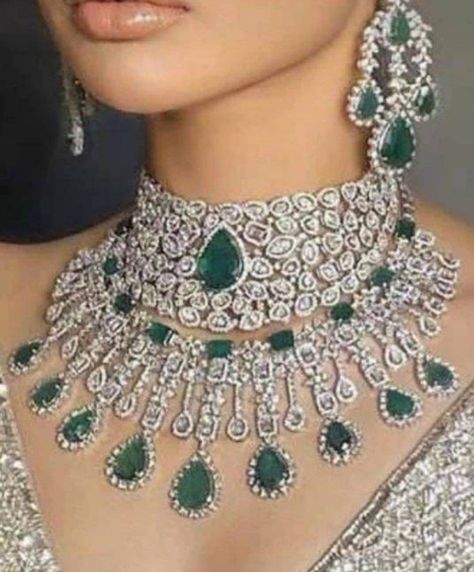 Silver Finish Emerald Cz Diamond 2 Necklace With Earrings Embellished with Green Stones. This beautifully handcrafted necklace is set in silver and copper alloy and plated with 22k gold and rhodium. Necklace Size Closure Adjustable Chain Earrings Closure - Push Pin The set includes 2 ) Necklace 1) Pair of Earrings 1)Maangtikka Style Tip - We love teaming this with classy chiffon sarees or zari silk sarees. Also looks best when worn with your royal whites, off whites, and gold. We recommend styli Bridal Jewelry Sets Brides, Bridal Diamond Necklace, Necklace Combo, Neck Pieces Jewelry, Chiffon Sarees, Bridal Jewellery Design, 2 Necklace, Stone Choker, Diamond Wedding Sets