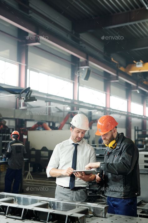 Engineering industrial machine by Pressmaster. Technician in formalwear using tablet while engineering industrial machine with factory worker in workshop #Sponsored #Pressmaster, #Technician, #machine, #Engineering Industrial Engineering Aesthetic, Engineer Photoshoot, Manufacturing Aesthetic, Engineering Photos, Engineering Industrial, Factory Photography, Job Pictures, Virtual Families, Truck Mechanic