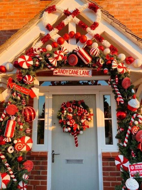 30 Gorgeous Christmas Front Porch Decoration Ideas To Wow Your Neighbors Candy Cane Theme Decorations Outdoor, Candy Cane Entryway, Candy Cane Door Garland, Outdoor Christmas Arch Ideas, Peppermint Porch Decor, Candy Cane House Outdoor, Candy Cane Christmas Outdoor Decorations, Candy Cane Lane Outdoor Decorations, Candy Cane Outdoor Christmas Decorations