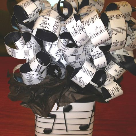 Centerpiece for music themed party. Printed music in paper, cut them in strips and curled them like ribbons. Attached to sticks and stuck them in sand in glass jars. Black tissue paper and printed music on paper wrapped around jar. Cheap and classy. Music Party Centerpieces, Music Theme Party, Music Centerpieces, Music Party Decorations, Music Theme Birthday, Music Themed Parties, Music Themed Wedding, Piano Recital, Musical Theme