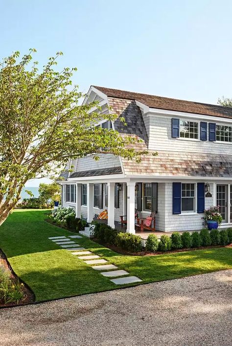 The origins of Cape Cod houses date back to the 1600s when the first Puritan settlers arrived in America. The humble architecture is similar to an English cottage, but a few features were adapted to withstand the harsh New England climate better. The steeply pitched roofs, for example, are designed to allow heavy snow to slide off more easily in the winter. Shutters were installed to help block strong winds. #capecodhouse #capecodhouseideas #homeexterior #architecture #bhg Humble Architecture, New England Cottage Exterior, New England Cottage, England Landscape, Cape Cod Cottage, Cape Cod Style House, Front Door Paint Colors, Ranch Exterior, Cape Cod Style