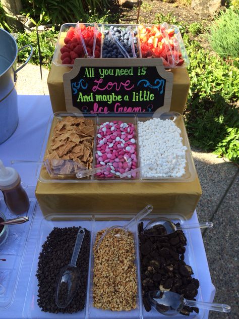 Ice Cream Bar at Bridal Shower. Elevate your toppings using different level wrapped boxes to match your theme! Ice Cream Themed Bridal Shower Ideas, Ice Cream Bridal Shower Theme, Ice Cream Bridal Shower Ideas, Ice Cream Bar Wedding Reception, Reception Food Station, Wedding Ice Cream Bar, Wedding Reception Food Stations, Bar Wedding Reception, Wedding Shower Themes