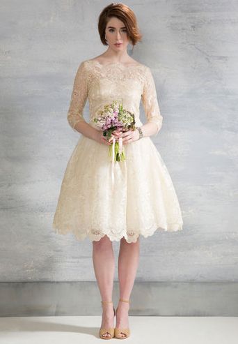 Short and sweet, this gorgeous knee-length dress is an excellent pick for brides who want to dance all night long without getting tangled in a long, elaborate train. Gilded Grace Dress in Champagne ($175, Modcloth.com) Modcloth Wedding Dress, Chi Chi London Dress, Retro Wedding Dresses, Short Lace Wedding Dress, Vintage Style Wedding Dresses, Wedding Champagne, Wedding Dress Champagne, Champagne Dress, London Dress