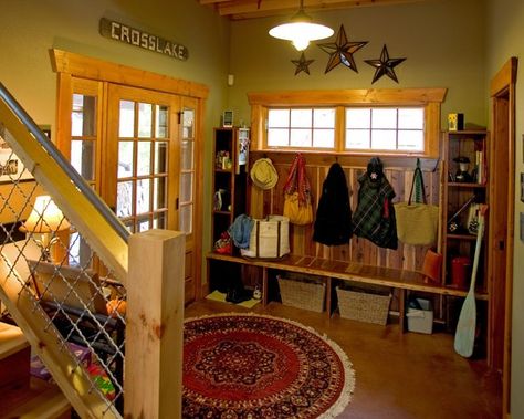 Arctic entry--typically the back entry.  A room with hooks, shelves and cubbyholes to hold boots and coats and whatnot that frequents in snowy weather.  Solid floors--tile or concrete--are a must to help minimize tracking snow in over wood or carpet.  Love the colors and natural wood trim. Cabin Entryway, Rustic Cabin Design, Natural Wood Trim, Rustic Entry, Rustic Entryway, Entry Design, Mud Room Storage, Rustic Cabin Decor, Cabin Style