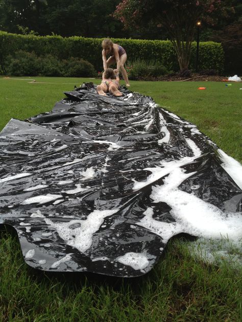 Homemade Slip-n-slide! Perfect for any summer day! Jut tape together garbage bags, secure it with some stakes (the type that hold x-mad lights) lather with soap and water and slide! Perfect DIY craft! Homemade Water Slide, Homemade Slip And Slide, Lake Party, Fun Group Games, Slip N Slide, Kids Indoor Playground, Water Day, Water Party, Summer Fun List