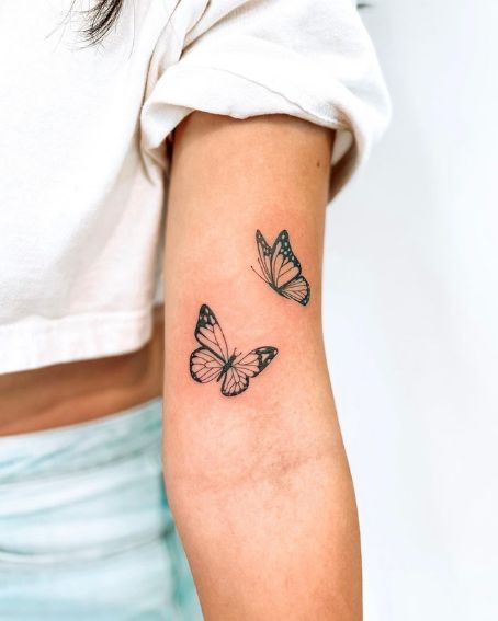 Tattoo Ideas Female Placement Arm, Tattoo Ideas Photo, Tattoos Inside Arm Women, 2 Butterfly Tattoo On Arm, Butterfly Tats On Arm, Bicep Butterfly Tattoo Women, Two Butterflies Tattoo Arm, Women’s Back Of Arm Tattoo, Butterfly Tattoo Inner Bicep