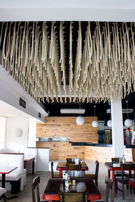 We used over 600 pieces of rope to transform the ceiling into a giant lamp, mimicking hanging spaghetti. ATMOSFERAS Interior design for the Italian restaurant Romanaccio. Rope Ceiling Design Restaurant, Rope Ceiling Design, Rope Ceiling, Pizza Store, Drop Ceiling Lighting, Fabric Installation, Factory Interior, Glamour Decor, Interior Ceiling Design