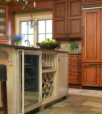 Show Off Your Wine Storage:  "Don't have the space for a separate wine bar? You can still showcase your collection by incorporating a wine bar into your kitchen island. This wine center includes a wine cooler for chilling bottles, a built-in rack, and slots for glasses. Just make sure to situate the wine center on the opposite side of the cooking area so it's easily accessible to guests." Modern Kitchen Island Design, Island Storage, Kitchen Island Storage, Wine Glass Storage, Kitchen Storage Ideas, Kitchen Island Bar, Modern Kitchen Island, Kitchen Island Design, Cooking Area