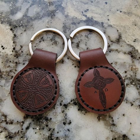 *Leather Cross Keychain. 2 Available Options: -Celtic Cross -Alpha and Omega Cross *Made from full grain leather (Cow Hide) keychain with a stainless steel key ring. Measurements: 1.33 inches (33 mm) width x 2.82 inches (71mm) length. *Handmade and hand stitched, engraved on the front and on the back (Cross) matching engraving on both sides. *Note: Leather is a natural material, and like all handmade items, there may be very minor imperfections or slight variations in color. Cross Keychain, Celtic Cross, Cow Hide, Leather Cross, Natural Material, Hand Stitched, Full Grain Leather, Key Rings, Key Ring