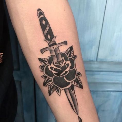 80 Rose and Dagger Tattoo Designs: A Blend of Beauty and Edge | Art and Design Dagger Rose Tattoo, Traditional Forearm Tattoo, Dagger Tattoo Traditional, Tattoo Old School Black, Knife And Rose Tattoo, Rose And Dagger Tattoo, Dagger Tattoos, Traditional Dagger Tattoo, Tato Tradisional