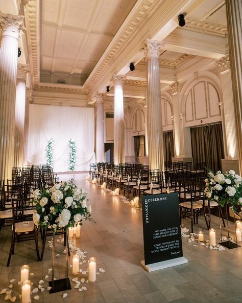 A wedding ready to welcome guests from every angle 🖤 Alana & Ryan | 10.28.2023 Florals | @tularosefloralevents Venue | @treasuryontheplaza Planning | @coastalcelebrationsstaug Photography | @angelita_photo Signage | @andimejiaco Rentals | @stjohnsilluminations ✿ #weddingflorist #floridaweddingflorist #staugustinewedding #staugustingweddings #staugweddings #thetreasuryontheplaza #thetreasury #treasurywedding #weddingflowers #moodyweddinginspo #floraldesigner #weddingarrangement #flor... Elegant Indoor Wedding Ceremony, Ceremony Flowers Indoor, Ceremony Decorations Indoor, The Plaza Wedding, Wedding Ceremony Design, Aisle Florals, Ceremony Decor Ideas, Treasury On The Plaza, Floral Arbor