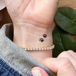 Tattoo Ideas Female Dog Paw, Small Tattoos Paw Print Dogs, Small Paw Print Tattoo Wrist, Dog Paw Tattoos For Women Ankle, Dog Paws Tattoo, Paw Print Tattoo Dog Small Ankle, Women Tattoo Placement, Discrete Tattoo, Small Phoenix Tattoos