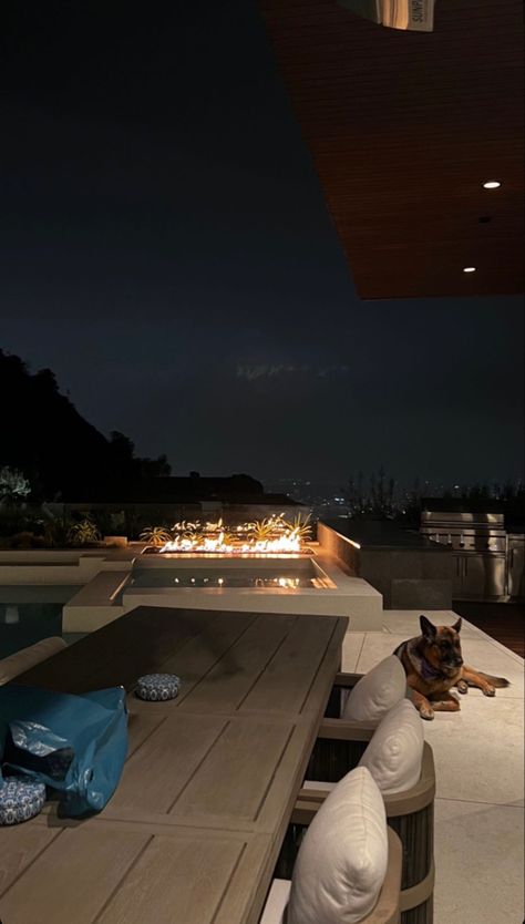 Los Angeles cozy evening outside with a german shepherd , infinity pool view over DTLA cream pillows earth tones interior design outdoor design fireplace California n Las Angeles Apartments, Los Angeles Aesthetic House, Los Angeles Luxury Apartment, California Mansion Interior, Penthouse In Los Angeles, California Mansion Aesthetic, Los Angeles Houses Aesthetic, Los Angeles House View, Los Angeles House Interior