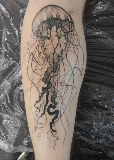 Jellyfish Tattoos: Meanings, Tattoo Designs & Ideas Jelly Fish Leg Tattoo, Jellyfish Tattoo On Calf, Jellyfish Shin Tattoo, Detailed Jellyfish Tattoo, Scary Jellyfish Tattoo, Goth Jellyfish Tattoo, Shark And Jellyfish Tattoo, Jellyfish Tattoo For Men, Jellyfish Tattoo Aesthetic