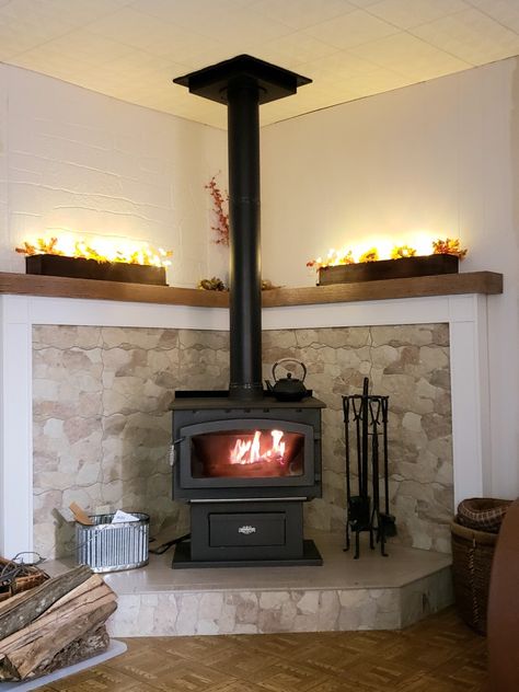 Tiled Wood Stove Hearth, Corner Hearth Ideas, Fireplace Platform, Wood Stove In Corner Of Living Room, Corner Woodstove Living Room, Freestanding Wood Stove Hearth Ideas, Corner Wood Burning Stove Mantle, Wood Stove Corner, Wood Stove In Corner