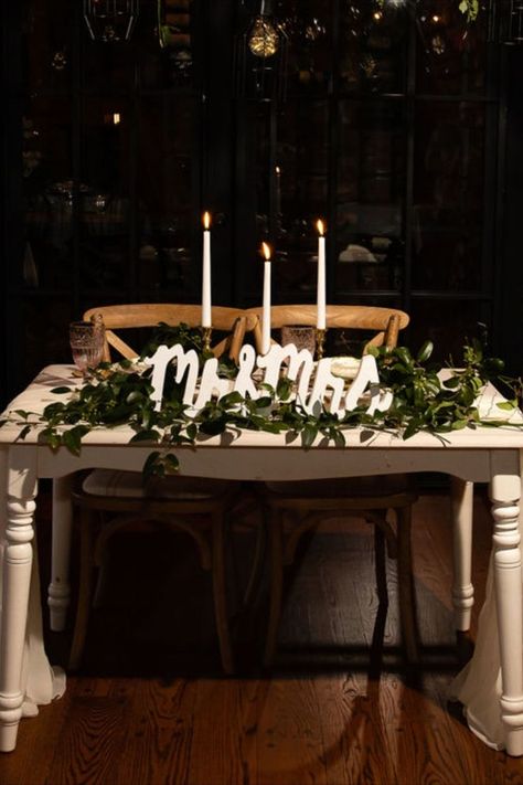 Wedding sweetheart table with greenery, a Mr and Mrs and candles. Sweetheart Table Seating, Simple Sweetheart Table, Romantic Sweetheart Table, Rustic Sweetheart Table, Wedding Sweetheart Table Decor, Head Table Wedding Decorations, Simple Wedding Reception, Cedar Sage, Champagne Wall