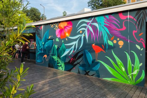 GRAFFITI ARTWORK | Client: Strandbar Herrmann  CONCRETE. THE GRAFFITI AGENCY #concrete #thegraffitiagency #vienna #austria #graffitiagency #graffiti #urbanart #streetart #interior #design #walldesign #tropical #flowers #art #artwork #graffitiartist #sprayer Foto: © Akos Vincze Murals Street Art Wall, Garage Mural, Exterior Murals, Wall Art Graffiti, Graffiti Flowers, Wall Art Mural, Garden Mural, Flower Mural, Food Wall Art