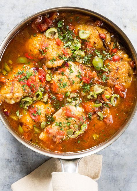 Basque-Style Chicken simmered in an easy sauce with roasted chili peppers, ham, tomatoes, garlic, and olives. Makes a warming, hearty dinner on a chilly night. #dinner #chicken Roasted Chili Peppers, Chicken With Peppers, Basque Food, Chicken Dishes Easy, 40 Birthday, Olive Recipes, Braised Chicken, Hearty Dinner, Chicken Stuffed Peppers