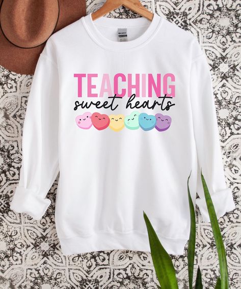 Get our Teaching Sweet Hearts Sweatshirt today! Made with love, this cozy and trendy sweatshirt is perfect for passionate educators. Inspire others with its heartwarming message and comfortable fit. Perfect as a gift or for yourself. Don't miss out! #TeacherLove #TeachingSweetHearts #PassionForEducation Teacher Cricut Ideas, Valentine’s Day Teacher Shirts, Teacher Valentines Shirt, Valentine Teacher Shirts, Valentines Teacher Shirt, Valentines Day Teacher Shirts, Teacher Valentine Shirts, Teacher Outfits 2023, Teacher Shirts Designs