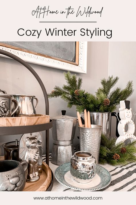 A winter vignette styled with pewter and silver accessories is perfect for the winter months Decorating With Pewter Pieces, Pewter Collection Display, Winter Kitchen Decor After Christmas, Pewter Display, Cottage Winter, Cozy Winter Fashion, Inexpensive Decor, Winter Decorating, Vintage Pewter