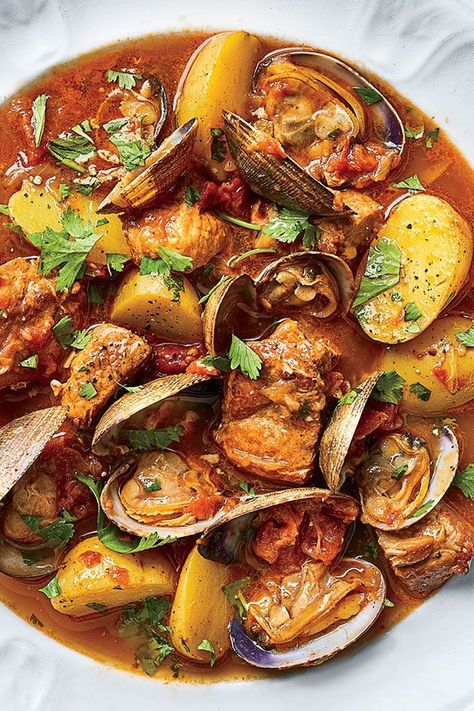 This Portuguese braised pork and clam recipe incorporates pork shoulders, garlic, white wine, onions, potatoes, clams, cilantro, lemon and crusty bread to create the ultimate comfort food meets seafood recipe.#comfortfood #seafoodrecipes #clamrecipes #porkrecipes #portugueserecipes Clams Recipe, Pork Shoulder Recipes, Pork Soup, Clam Recipes, Braised Pork, Pork Shoulder, Portuguese Recipes, Pork Dishes, Stew Recipes