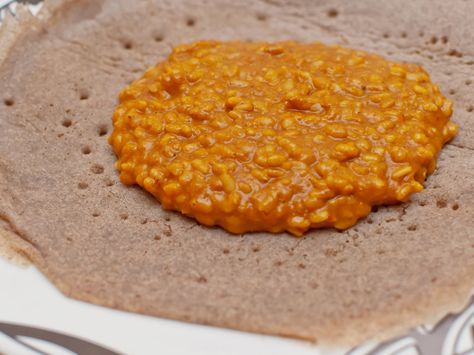 Mesir wat, or misir wat, is a spiced puree of red lentils, one of several types of bean or lentil stews that are served with Ethiopian meals. Mesir Wat, Misir Wat, Ethiopian Dishes, Ethiopian Recipes, Ethiopian Cuisine, African Foods, Ethiopian Food, Red Lentils, Nigerian Food