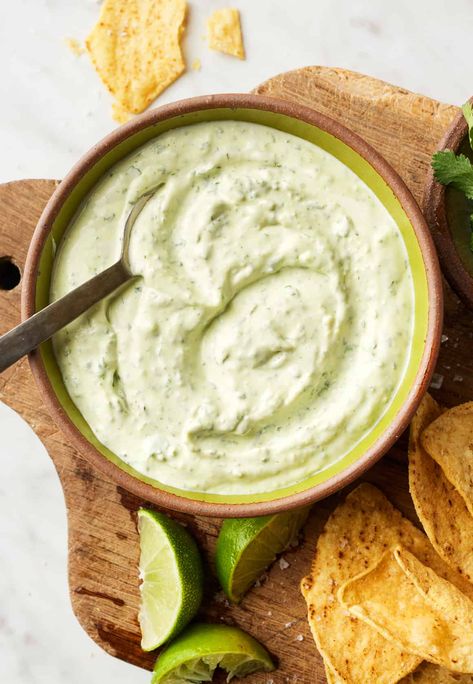 This easy cilantro lime crema adds zesty flavor to tacos, burritos, grilled veggies, and more! It's made with simple, healthy ingredients like Greek yogurt, garlic, fresh cilantro, and lime juice. Cilantro Lime Crema Recipe, Lime Crema Recipe, Cilantro Lime Crema, Crema Recipe, Lime Crema, Grilled Sweet Potatoes, Zesty Sauce, Tacos Burritos, Full Fat Yogurt