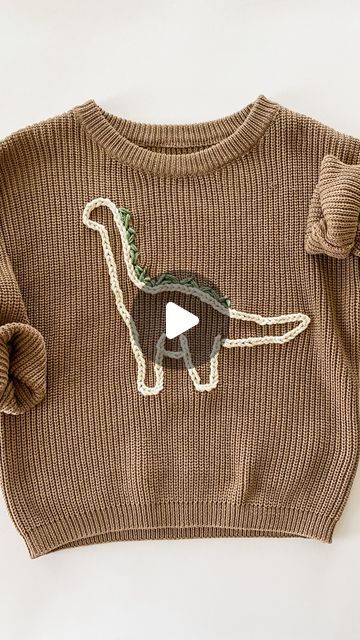 Sarah - DIY Embroidery Kits & Patterns on Instagram: "Made this sweater for my little boy! I don’t think I ever shared how I got the Dino pattern onto the sweater. Basically I drew a Dino and then cut it out creating a stencil of sorts. Then I traced it onto the sweater 🦕   If you want to learn to embroider on a sweater, comment “sweater stitch along” and I’ll DM you the link for my virtual class. It  will teach you how to make one of those cute name sweaters using a pattern that’s says “hello” - but you could totally take what you learn and embroider a dinosaur or flower or whatever you want 🫶🏻" Little Boy Embroidery Ideas, Boy Embroidered Sweater, Boys Embroidered Sweater, Sweater Embroidery Diy, Racoon Embroidery, Boy Embroidery Ideas, Embroidery Sweater Diy, Learn To Embroider, Dino Pattern