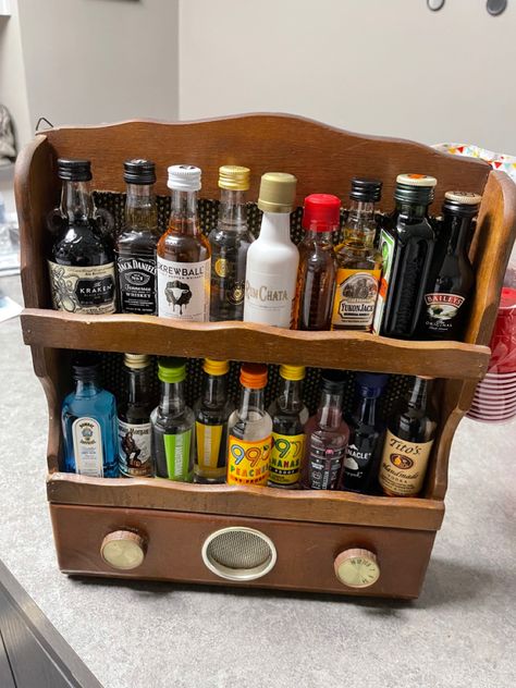 A vintage display rack and mini alcohol bottles Alcohol Mini Bottles Gift Ideas, Small Alcohol Bottles Gifts, Alcohol Storage Ideas, Mini Bottles Of Alcohol Gifts, Miniature Alcohol Bottles Gift Ideas, Brighton Apartment, Alcohol Accessories, Alcohol Cabinet, Tiny Liquor Bottles