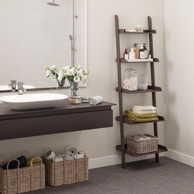 This leaning wooden bookshelf can be used for storing, displaying, organizing, or other indoor uses. Our 5-tier leaning ladder-style shelf has a trendy yet timeless style that can be used to organize your home office, neatly store towels and toiletries in a bathroom, display photos in your living room or keep kitchen supplies easily accessible. This angled shelf has a lightweight design and can lean against wall surfaces. The modern ladder bookcase is designed in a contemporary, minimalist, mode Ladders For Decoration Farmhouse Decor, Bathroom Ladder Decor, Shelf Over Sink, Bathroom Ladder Shelf, Bathroom Towel Shelf, Wooden Shelf Unit, Bathroom Display, Wooden Ladder Shelf, Leaning Shelf