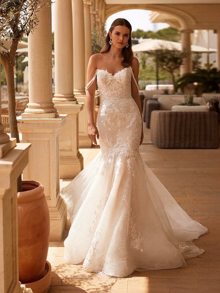 Bride walking in lace applique drop waist wedding dress with pointed sweetheart neckline and triple strand off the shoulder strands Mermaid Wedding Dress V Neck, Alencon Lace Wedding Dress, Shoulder Applique, Wedding Dress V Neck, Waist Wedding Dress, Drop Waist Wedding Dress, Strapless Wedding Dress Mermaid, Moonlight Bridal, Classic Elegant Wedding