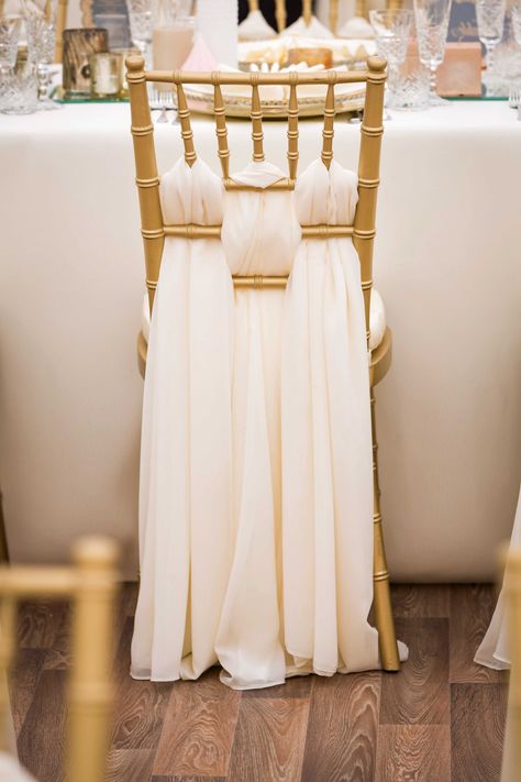 Make your wedding chairs extra special by adding a decorative accent to the back of each one.A simple,draped piece of ivory-colored fabric is an elegant contrast to the regal gold color of the Chiavari Chairs.Woven through the chair back gives a unique intricate style to any wedding reception. Chair Sashes Wedding, Bridal Chair, Chair Sashes, Chair Covers, Wedding Party, Chiffon, Gold, White