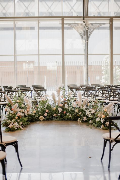 Semi circle floral floor installation for a wedding ceremony in the conservatory room at The Depot in Minneapolis. Floral by Studio Fleurette. Floral Nest Ceremony, Semi Circle Wedding Ceremony Flowers, Floor Altar Wedding, Flower Semi Circle Wedding, Ceremony Floor Arch, Floor Floral Arrangements Wedding Ceremony, Floor Arch Wedding Ceremony, Wedding Alter Floor Flowers, Wedding Floral Floor Arrangements