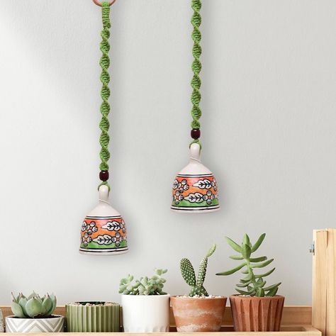 Bring a serene melody to your garden or balcony with our ceramic hanging bells, featuring beautiful macrame details. Swipe through to find your favorite shade ✨ Product Code: GA013A Tap on the link in bio to Shop Now! [Tesoro Store, Small Business, Small Biz Love, Marketplace, Shop Now, Ceramic Bells, Home Decor] Ceramic Bell How To Make, Bell Wall Hanging, Ceramic Bells Decor, Hanging Bells Decoration Indian, Crochet Bell Hanger, Ceramic Bells, Ceramic Bell, Hanging Bell, Macrame Ideas