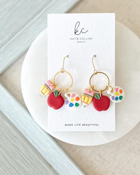 Classroom couture is available now 🍎 #teacher #teacherlife #teacherstyle #polymerclay #polymerclayearrings #etsyfinds #etsyseller Earring Backing Card Design, Teacher Earrings Clay, Painted Pencils, Collins Design, Teacher Earrings, Paint Palettes, Favorite Teacher, Earring Cards, Polymer Clay Charms