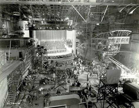 This amazing shot was taken on soundstage 21 at the Warner Bros studios in Burbank. 843 people are on set to film a musical number called “This Time Is the Last Time” for “This Is the Army” which was filmed during February through May 1943 and released in August. The number took three weeks of rehearsal and five days to film. It was worth the effort though. “This Is the Army” was the highest grossing movie that year, and the highest-grossing musical until “White Christmas” surpassed it in 1954. Movie Studio Set, Garden Of Allah, Sea Hawk, Charlie Parker, Film Life, Warner Bros Studios, Lions Gate, Movie Studios, Hollywood Studio