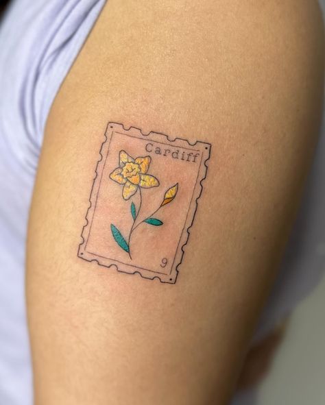 Crayon stamp tattoo to celebrate time in wales I am booking April onwards, DM TO ENQUIRE ABOUT YOUR NEXT TATTOO 💖 . . . . . . . #stamp #stamptattoo #bristol #bristoltattoo #bristoltattooartist #bristoltattoostudio #tattoo #tattoos #uktattoo #tattoouk #daffodil #fineline #finelinetattoo #finelinetattoos #colourtattoo #tattooideas #tatt #patchworktattoo . Would you get a stamp tattoo? Wales Tattoo, Postage Stamp Tattoo, Tattoo Uk, Stamp Tattoo, Scary Tattoos, Next Tattoo, Fine Line Tattoos, Tattoo Inspo, Postage Stamp