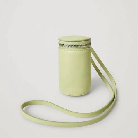 Charm everyone around you with this beautiful COS MINI CYLINDER DUFFEL LANYARD GRASS GREEN 💚 Miniature with maximum impact. Made from leather this lanyard has a cylindrical duffel bag with an exposed zip closure. A statement accessory. Leather lanyard with mini cylinder duffel bag. Zip closure. Discover more beautiful accessories from Carrie Me Around on ✨TheAccessoryCircle.com✨ #accessorycircle Go to 💍 tinyurl.com/selltac 👡 sell with us. Cylinder Bag Pattern, Crochet Cylinder Bag, Cylinder Bag, Modern Pouch Bucket Bag With Gold-tone Hardware, Eco-friendly Rectangular Bucket Bag With Detachable Handle, Cos Bags, Leather Lanyard, Duffel Bag, Miniatures