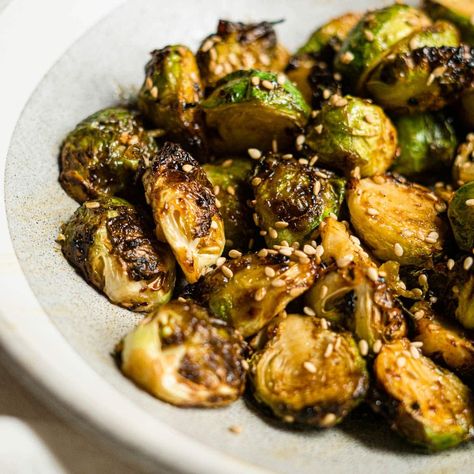 Miso Glazed Brussels Sprouts Roasted miso glazed Brussels sprouts tossed with a garlicky, sweet and savory miso glaze. Crisp edges and a tender middle makes it the perfect side dish, snack, or an appetizer. Miso Brussel Sprouts, Brussels Sprouts Roasted, Glazed Brussels Sprouts, Bruschetta Appetizer, Caramelised Onion Tart, Onion Tart, Miso Glaze, Mexican Street Corn Salad, Tomato Bruschetta