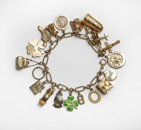 Vintage Charm Bracelet from Lang Antiques and Estate Jewelry. A collection of 14-karat charms, some of which have movable parts. Charms include a beer stein, two lucky clovers, a purse and a safe that opens to reveal a folded $1 bill. Photo: Russell Yip, The Chronicle http://www.sfchronicle.com/style/article/Strike-it-lucky-this-St-Patrick-s-Day-with-6130621.php?t=2699261f56f294ee0d&cmpid=twitter-premium#photo-7619103 Chunky Charm Bracelet, Auction Catalog, Solid Gold Charms, Pearl Drop Necklace, Vintage Charm Bracelet, Turtle Charm, Gold Charm Bracelet, Yellow Gold Bracelet, Handmade Gold